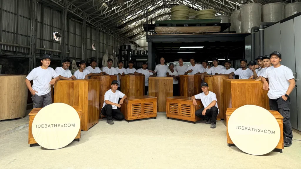 Artisans proudly showcasing handcrafted teak ice baths, embodying the essence of premium cold therapy solutions.