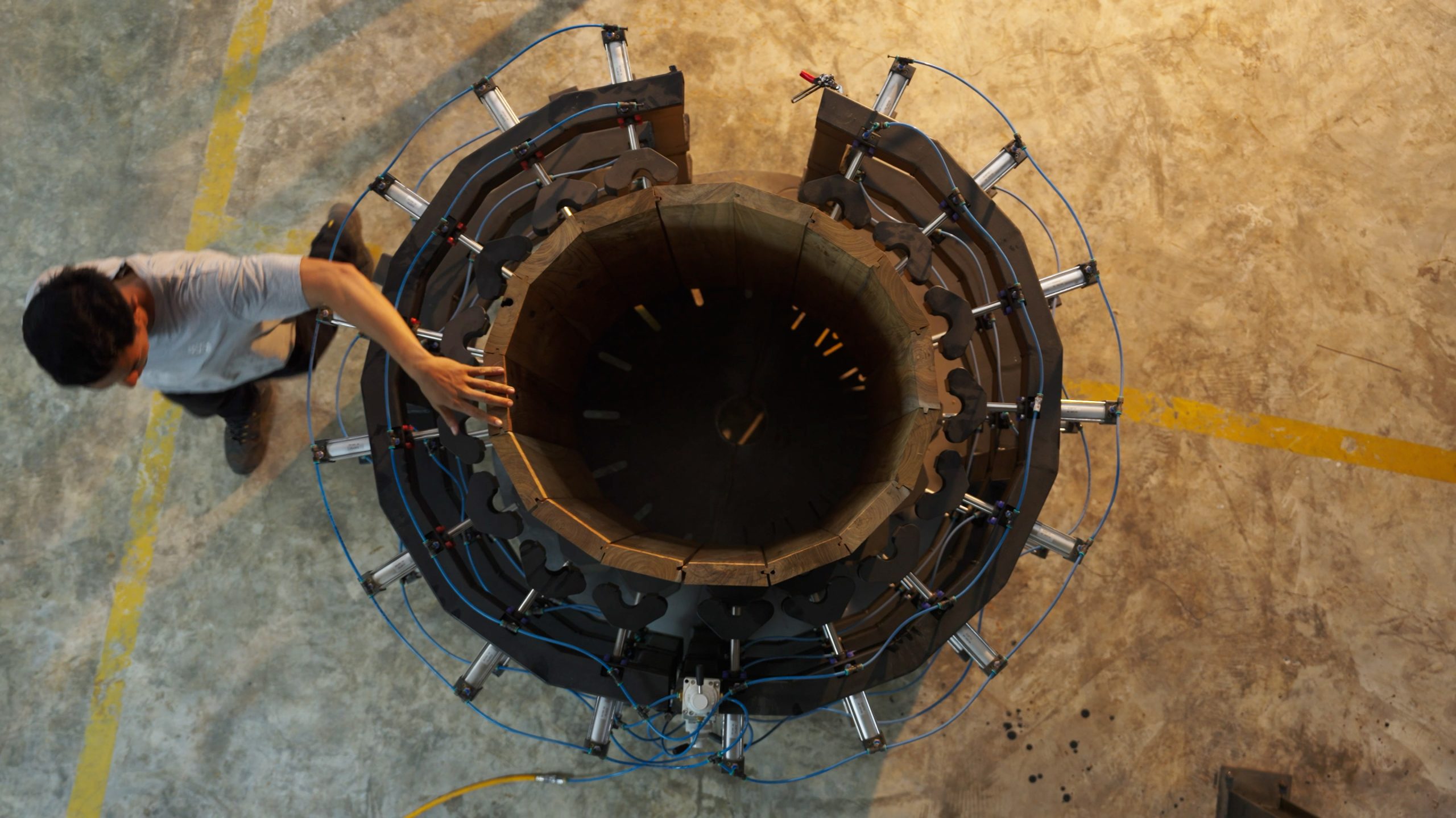 Overhead view of teak planks clamped into position during ice bath production at the icebaths.comm Bali workshop