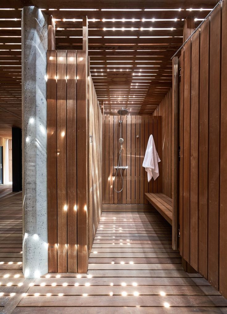 a luxury changing room with marble flooring and wooden panelling for the walls