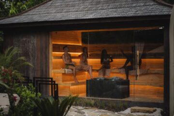 Wood-lined Finnish sauna with a stone heater and ladle, showing the classic high-heat environment used in landmark sauna studies
