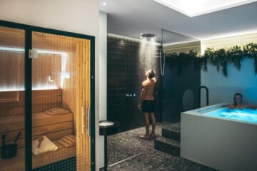 At-home hot-to-cold recovery space showing a compact sauna beside a cold plunge in calm morning light