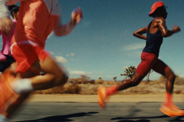 Close-up of a runner’s lower legs mid-stride on pavement, representing endurance training and the role of ice baths in running recovery.