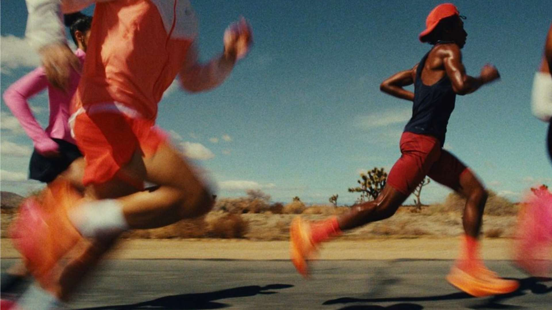 Close-up of a runner’s lower legs mid-stride on pavement, representing endurance training and the role of ice baths in running recovery.