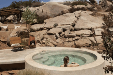 Person calmly immersed to the shoulders in a cold plunge pool, illustrating normal ice bath side effects and safe cold water immersion practice.