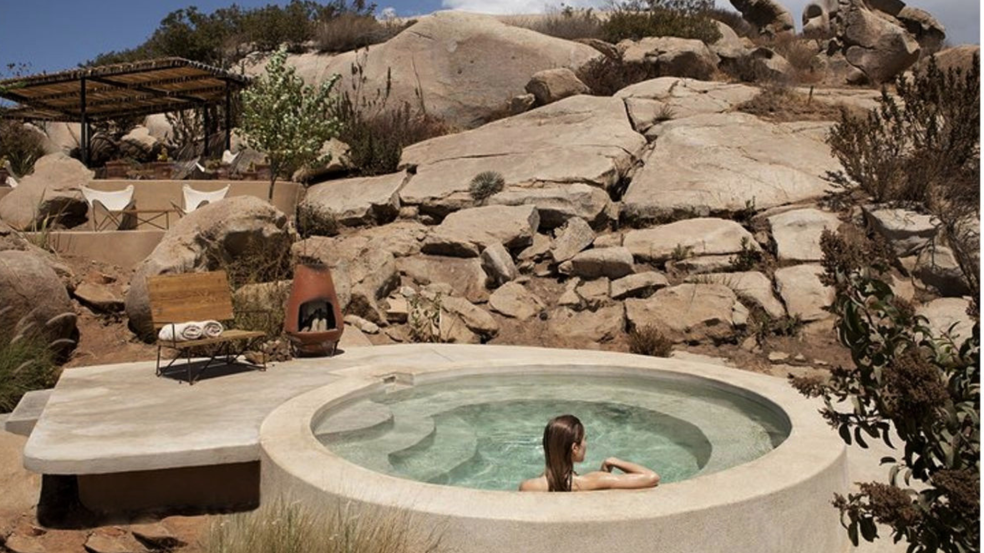 Person calmly immersed to the shoulders in a cold plunge pool, illustrating normal ice bath side effects and safe cold water immersion practice.