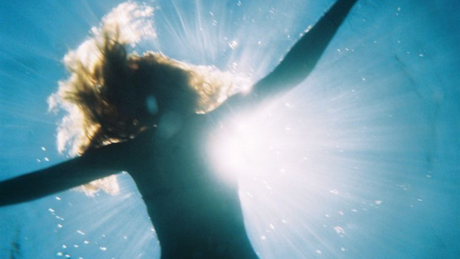 Calm close-up of hands in cold water in a simple plunge, representing how often to do contrast therapy as a repeatable weekly practice
