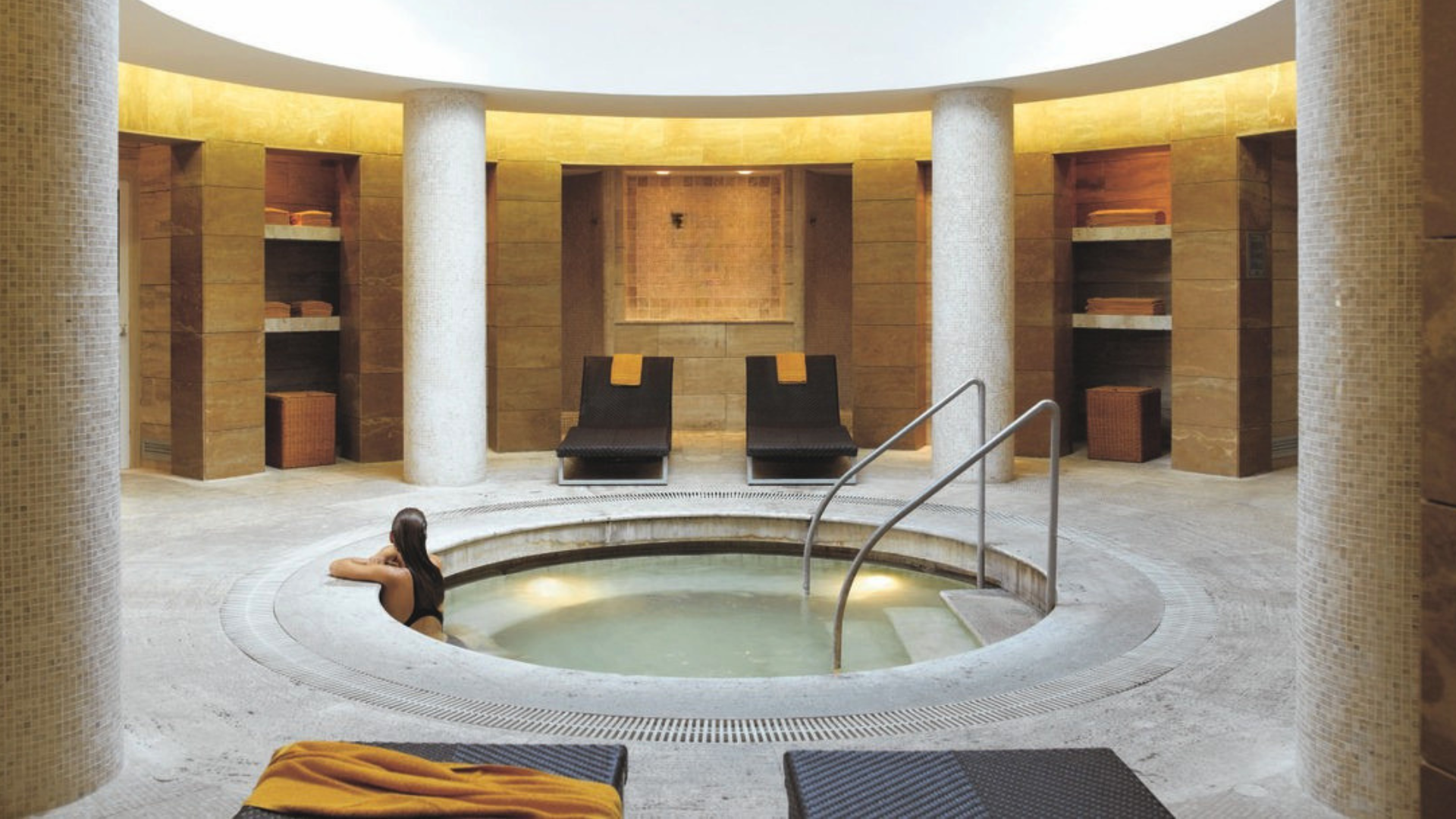 Close-up of hands resting calmly on the edge of a cold plunge pool in soft morning light, representing a daily ice bath habit in the first 30 days