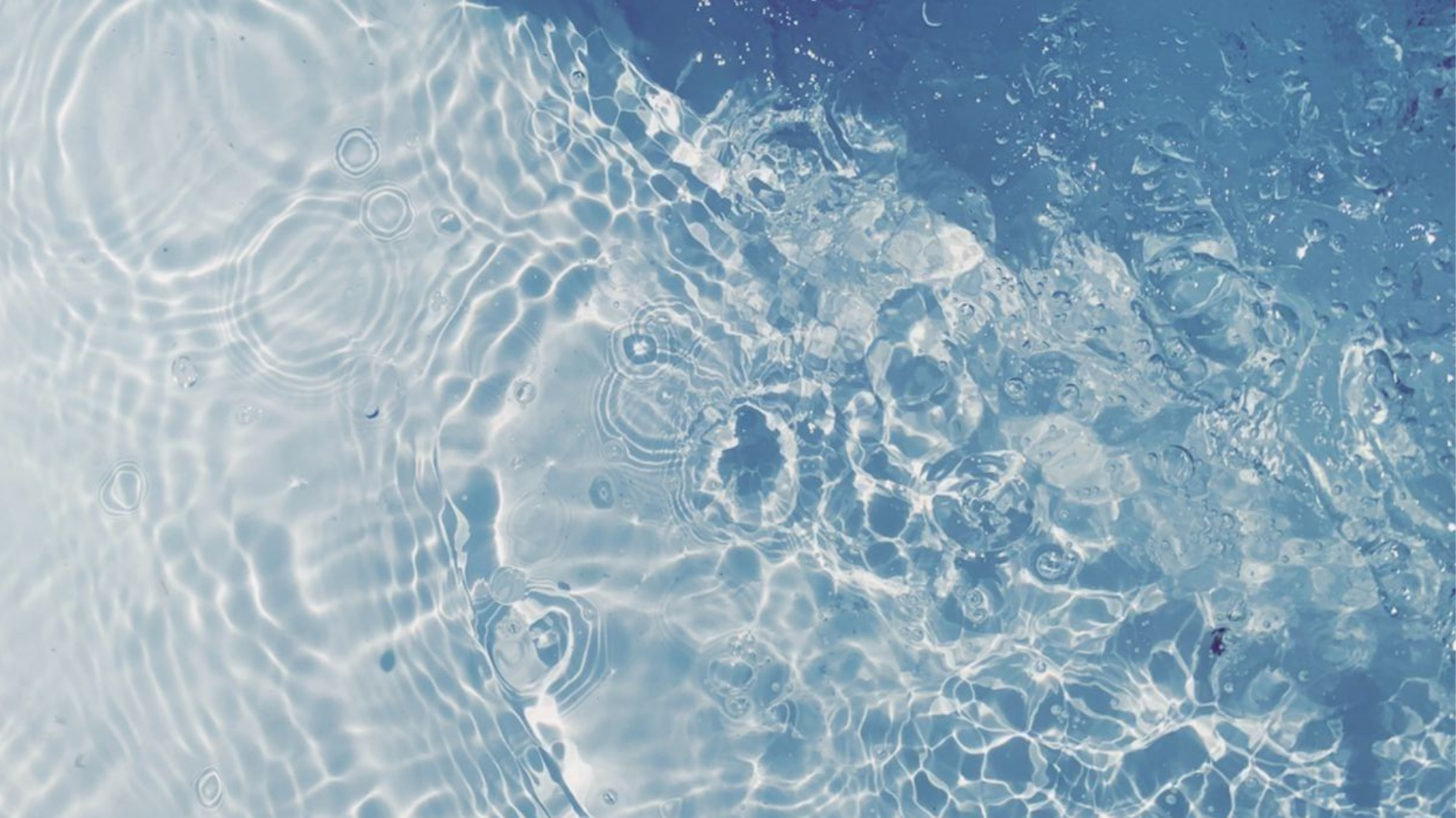 Macro view of a dark water surface where two ripple patterns collide, representing why ice bath studies can reach different conclusions.
