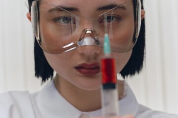 a dermatologist prepearing to inject a face filler.
