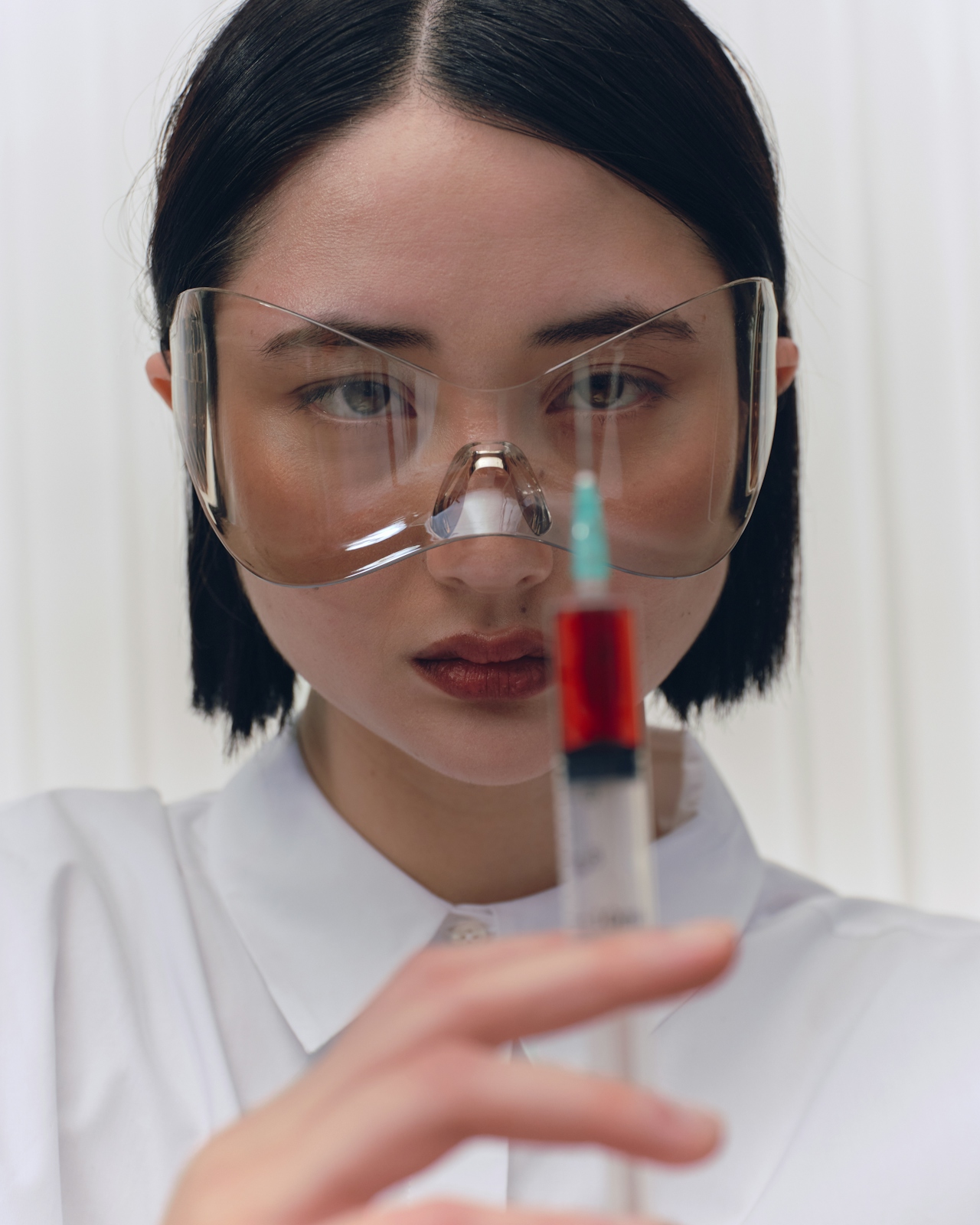 a dermatologist prepearing to inject a face filler.