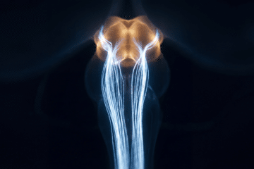 Microscopy-style image showing focused neural activity traveling from the neck to the brainstem in blue and amber tones, illustrating parasympathetic activation linked to vagus nerve icing.