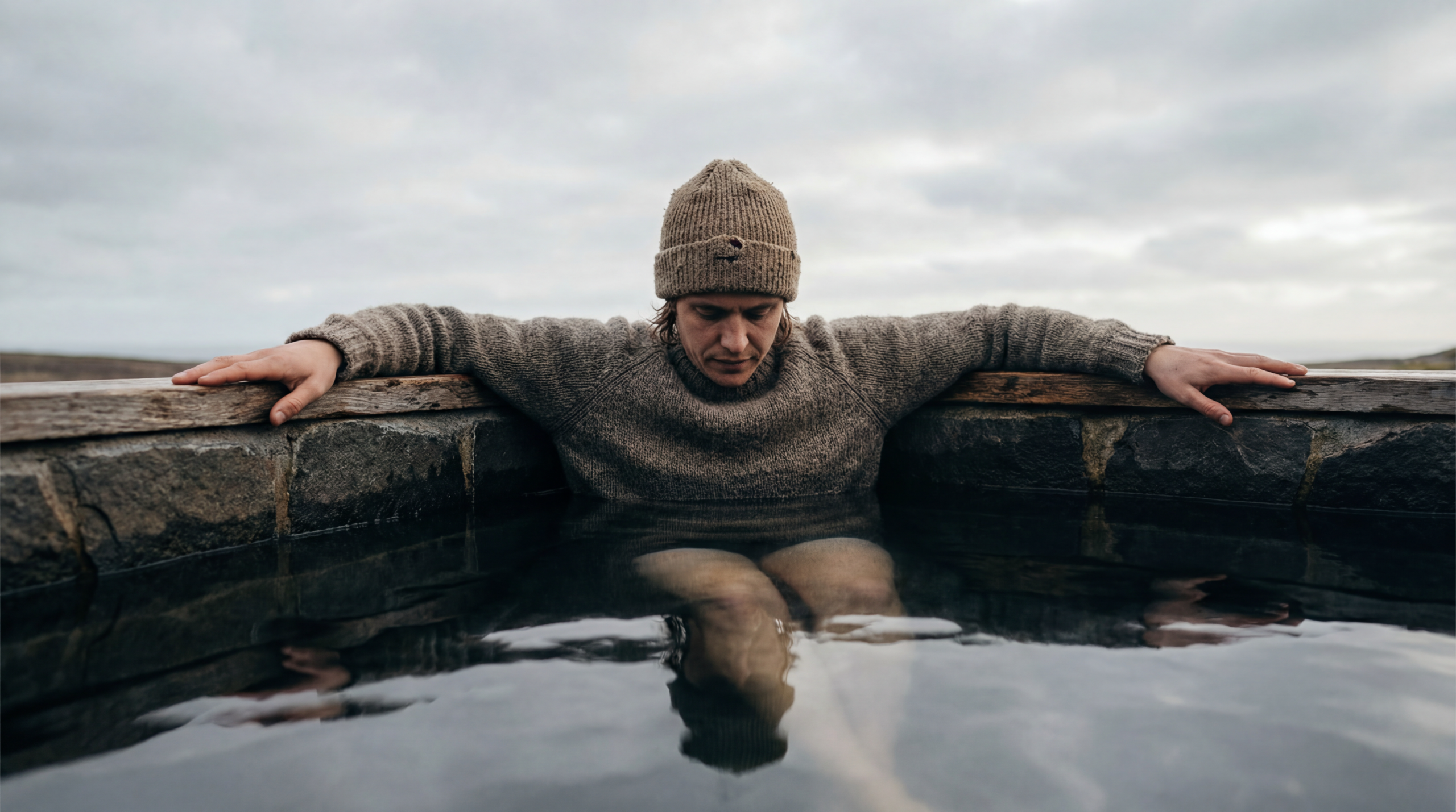 Person calmly immersed to the shoulders in a cold plunge pool, illustrating a goal-based ice bath protocol for temperature and duration.